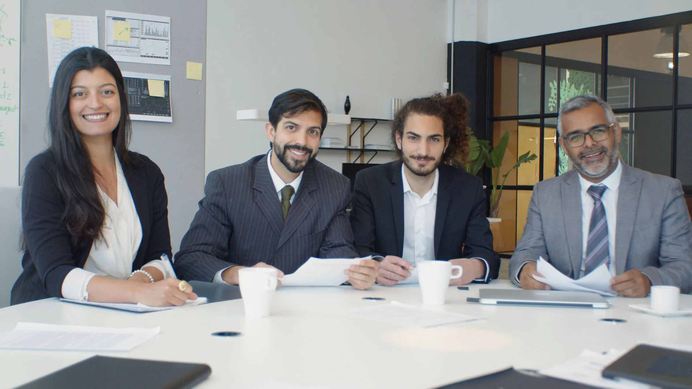 Members of the team seated together at a meeting table