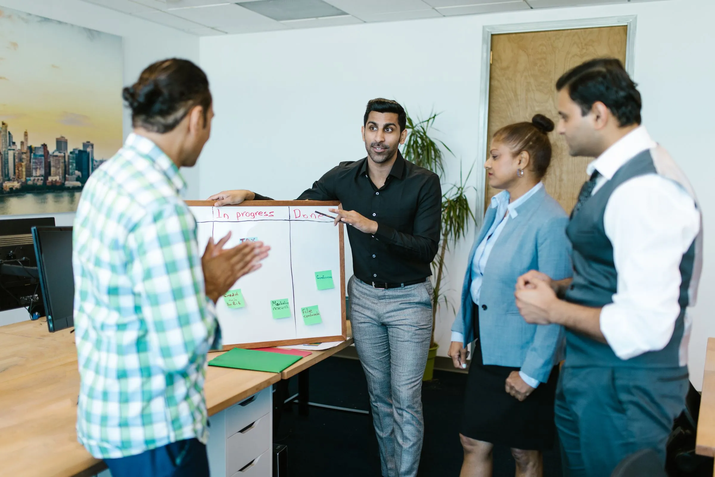 An operations team reviewing a workflow board together